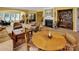 Open-concept living room with a fireplace, large windows, and dining area with a round wooden table at 8107 Crater Lake Dr, Indian Land, SC 29707