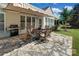 Outdoor patio with stone flooring, awning, barbecue and outdoor table set at 8107 Crater Lake Dr, Indian Land, SC 29707