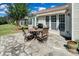 Outdoor patio with stone flooring, awning, barbecue and outdoor table set at 8107 Crater Lake Dr, Indian Land, SC 29707