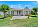 Exterior view of a charming backyard with a stone patio, well-maintained lawn and mature trees at 8107 Crater Lake Dr, Indian Land, SC 29707
