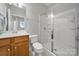Bathroom featuring a glass-enclosed shower, wood vanity and framed mirror, offering a clean and updated design at 8107 Crater Lake Dr, Indian Land, SC 29707