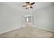 Neutral bedroom with double doors, carpet floors, ceiling fan and neutral colors to unwind at 8107 Crater Lake Dr, Indian Land, SC 29707