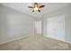 Bedroom with carpet flooring, ceiling fan and large closet space, offering ample storage at 8107 Crater Lake Dr, Indian Land, SC 29707