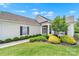 Charming single story home featuring a manicured lawn and mature landscaping at 8107 Crater Lake Dr, Indian Land, SC 29707