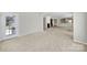Open-concept living room with fireplace, neutral paint, access to the outdoors, and modern finishes at 8107 Crater Lake Dr, Indian Land, SC 29707