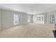 Bright living room features large windows, neutral paint, and a fireplace for cozy evenings at 8107 Crater Lake Dr, Indian Land, SC 29707
