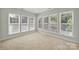 Inviting sun room filled with natural light from many windows, providing a warm and relaxing space at 8107 Crater Lake Dr, Indian Land, SC 29707