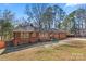 Beautiful brick home features updated orange wooden accents and a well manicured lawn at 851 Gist Rd, Rock Hill, SC 29732