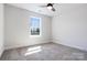 Cozy bedroom features plush carpeting, a ceiling fan, and a large window with a view at 1044 Margrace Rd, Kings Mountain, NC 28086