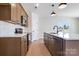 Updated kitchen with stainless steel appliances, wood cabinets, and island sink at 1044 Margrace Rd, Kings Mountain, NC 28086