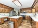 Kitchen with stainless steel appliances, white countertops, wood cabinets and wood flooring at 10519 Annalexa Ln, Charlotte, NC 28277