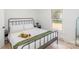 Bright bedroom with a black metal bed frame, tray with fruit, and a window with natural light at 108 Arlene Ave, Kannapolis, NC 28081