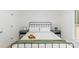 Bright bedroom with a black metal bed frame, tray with fruit, and neutral decor at 108 Arlene Ave, Kannapolis, NC 28081