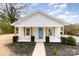 Charming home featuring new landscaping, rustic wood accents and a welcoming covered front porch at 108 Arlene Ave, Kannapolis, NC 28081