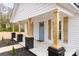 Inviting front porch with craftsman columns and a light blue front door at 108 Arlene Ave, Kannapolis, NC 28081