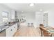 Open kitchen with stainless appliances, modern countertops, hardwood floors, and eat-in dining area at 108 Arlene Ave, Kannapolis, NC 28081