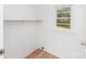 Bright laundry room with wood-look flooring, shelving and a window for natural light at 108 Arlene Ave, Kannapolis, NC 28081