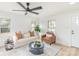 A spacious living room with white paint, lots of natural light, hardwood floors, and a ceiling fan at 108 Arlene Ave, Kannapolis, NC 28081