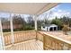 Back porch with wooden railings and steps offering views of the backyard and detached garage at 108 Arlene Ave, Kannapolis, NC 28081