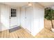 Inviting covered porch with a bright white door, striped mat, and fresh wood flooring at 108 Arlene Ave, Kannapolis, NC 28081