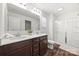 Bathroom features a double sink vanity with dark wood cabinets and a glass-enclosed shower at 11207 Argosy Dr, Lancaster, SC 29707