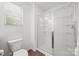 Bathroom features a glass-enclosed shower and a toilet under a bright window at 11207 Argosy Dr, Lancaster, SC 29707
