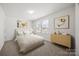 Bright bedroom features neutral carpeting, modern art and bright window views at 11207 Argosy Dr, Lancaster, SC 29707