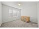 Bright bedroom features neutral carpeting, a bright window views and a crib at 11207 Argosy Dr, Lancaster, SC 29707