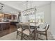Cozy dining area featuring a modern light fixture, seamlessly connecting to the kitchen at 11207 Argosy Dr, Lancaster, SC 29707