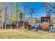 Rustic cabin exterior with stone chimney, wood accents, and scenic lake views, perfect for nature lovers at 11207 Argosy Dr, Lancaster, SC 29707