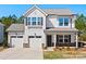 Charming two-story home with white siding, stone accents, and a two-car garage, perfect for suburban living at 11207 Argosy Dr, Lancaster, SC 29707