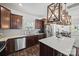 Modern kitchen features stainless steel appliances, dark wood cabinets, and stylish wooden light fixtures at 11207 Argosy Dr, Lancaster, SC 29707