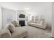 Bright living room with a fireplace, large windows, and two cozy sofas at 11207 Argosy Dr, Lancaster, SC 29707
