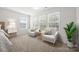 Bright main bedroom sitting area features neutral carpeting and bright tree views through the shuttered windows at 11207 Argosy Dr, Lancaster, SC 29707