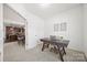 Bright home office with a minimalist desk and decor adjacent to dining room at 11207 Argosy Dr, Lancaster, SC 29707
