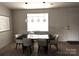 Dining room features modern lighting, a large window, and stylish decor creating an inviting atmosphere at 121 Irving Ave, Mooresville, NC 28117