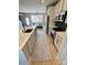 Modern kitchen with stainless steel appliances and ample counter space overlooks a bright living area at 121 Irving Ave, Mooresville, NC 28117