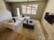 Stylish living room showcasing a large window, modern furnishings, and beautiful flooring at 121 Irving Ave, Mooresville, NC 28117