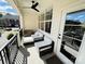 Cozy covered patio with modern furniture and a ceiling fan for comfortable outdoor living at 121 Irving Ave, Mooresville, NC 28117