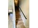 Elegant staircase features light wood steps and a sleek black handrail, adding modern touch at 121 Irving Ave, Mooresville, NC 28117