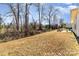 Lawn of the backyard with a view of the surrounding trees and patio seating area at 156 Sugar Hill Rd, Troutman, NC 28166