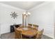 Formal dining area featuring a round wooden table, six chairs, elegant chandelier, and decorative wall accents at 156 Sugar Hill Rd, Troutman, NC 28166