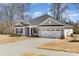 Charming one-story home with a well-manicured front yard and a two-car garage at 156 Sugar Hill Rd, Troutman, NC 28166