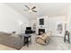 Bright living room with a ceiling fan, fireplace, neutral walls, comfortable couches, and plenty of natural light at 156 Sugar Hill Rd, Troutman, NC 28166