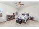 Spacious main bedroom with a large window, a ceiling fan, and rustic wooden furniture for a cozy retreat at 156 Sugar Hill Rd, Troutman, NC 28166