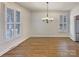 Dining room with hardwood floors, a chandelier, and plantation shutters at 15604 Waterfront Dr, Huntersville, NC 28078