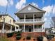 Charming two-story home featuring a double porch and gray siding, creating a welcoming and stylish exterior at 15604 Waterfront Dr, Huntersville, NC 28078