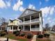 Charming two-story home with double front porches, brick foundation and landscaped yard at 15604 Waterfront Dr, Huntersville, NC 28078