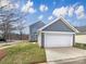 Charming two-story home with attached garage, blue siding, and well-manicured lawn at 15604 Waterfront Dr, Huntersville, NC 28078