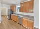 Well-lit kitchen featuring wood cabinets, stainless steel appliances, and a double basin sink at 15604 Waterfront Dr, Huntersville, NC 28078